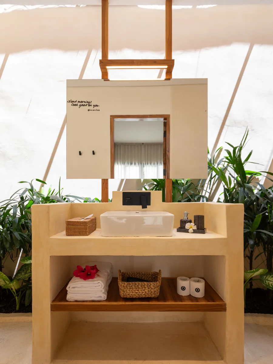 Private bathroom with plants and natural light