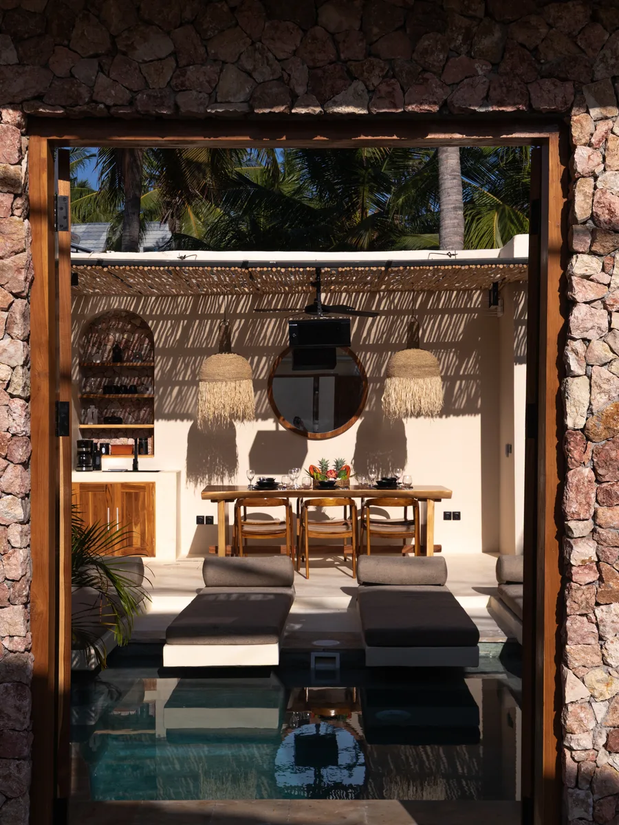 Stone entrance gate opening to the pool