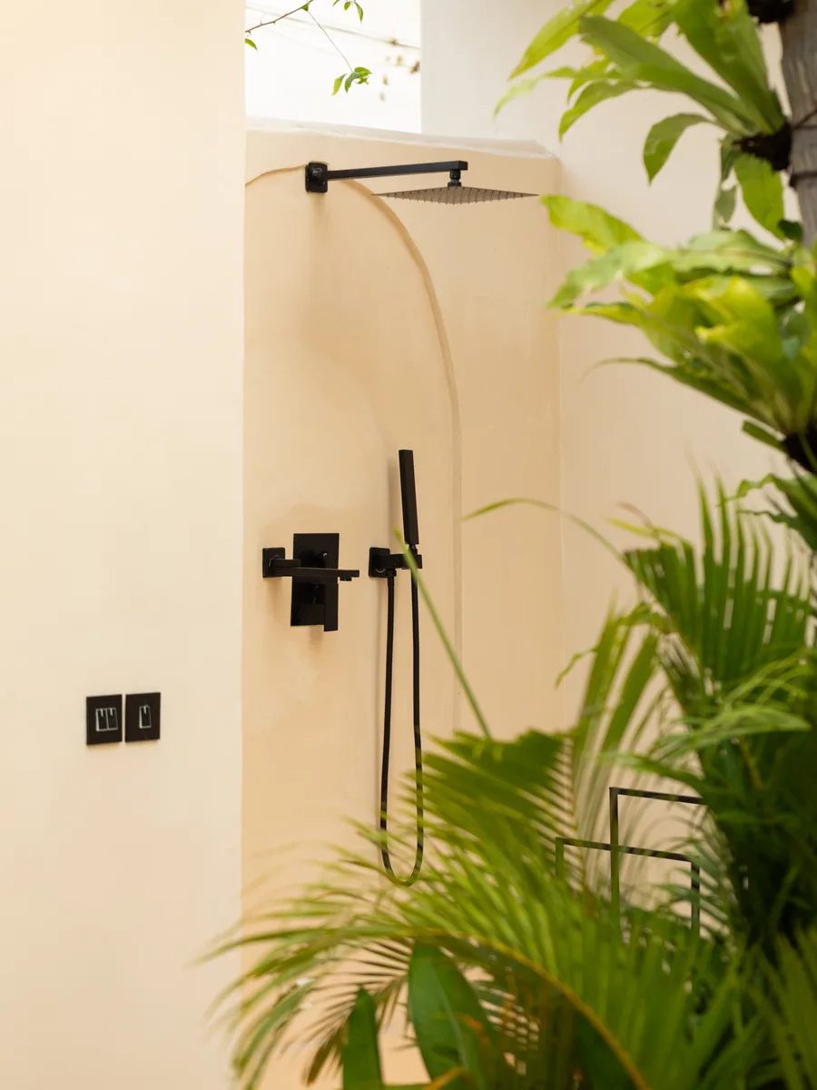 Outdoor shower with tropical plants